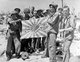 USA / Japan: Marines and Coast Guardsmen, who stormed and captured Engebi Island in the Marshalls, display a bullet-riddled Japanese flag
